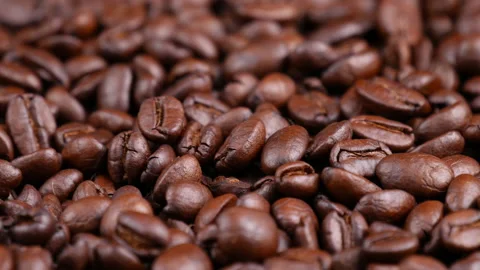Roasted coffee beans spinning, top view. Coffee close up Video stock 165337197