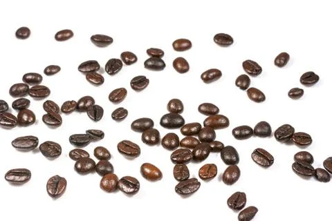 Roasted coffee beans splatter isolated on a white background. Stock Photos
