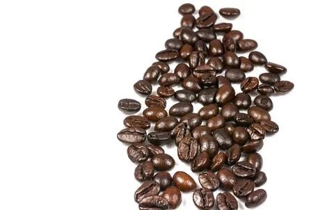 Roasted coffee beans splatter isolated on a white background. Stock Photos