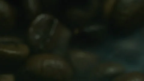 Roasted Coffee Beans With Swirling White Smoke on Black Background Video stock 324802422