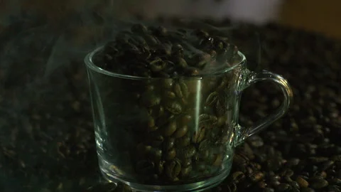Roasted Coffee Beans With Swirling White Smoke on Black Background Copy Video stock 324812980