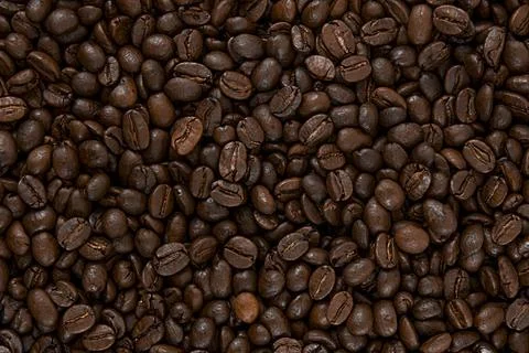 Roasted coffee beans. Texture of coffee beans. Coffee background. Stock Photos