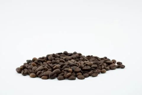 Roasted coffee beans on white background. Stock Photos