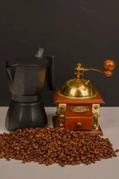 Roasted coffee beans on white background with coffee grinder and coffee maker Stock Photos
