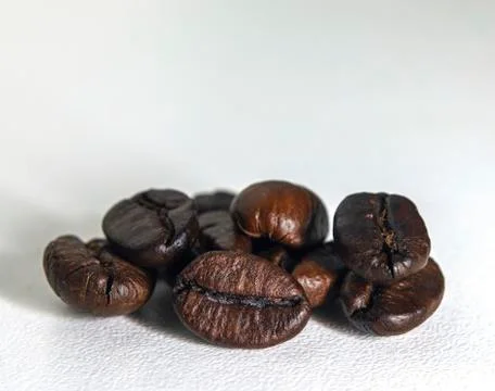 Roasted coffee beans on white background. Stock Photos