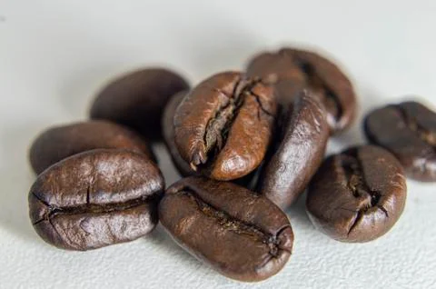 Roasted coffee beans on white background. Stock Photos