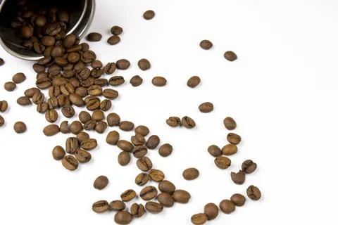 Roasted coffee beans on a white background. Overturned coffee can, coffee bea Stock Photos