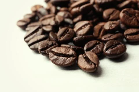 Roasted coffee beans on white background, closeup Stock Photos