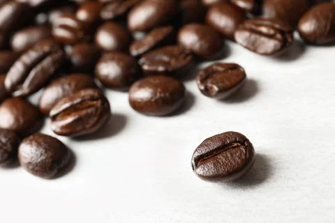 Roasted coffee beans on white background, closeup Stock Photos