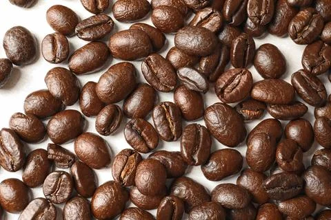 Roasted coffee beans on white background, top view Stock Photos