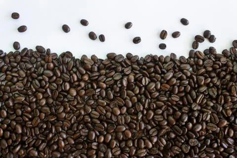 Roasted coffee beans on white background.Creative background concept. Stock Photos