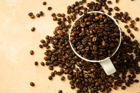Roasted coffee beans in a white ceramic mug Stock Photos