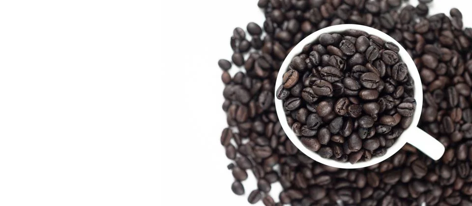 Roasted coffee beans in white glass on white background Stock-Fotos