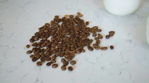 Roasted coffee beans on a white marble table background. 스톡 동영상 161112006