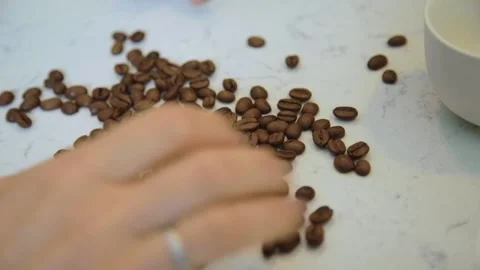 Roasted coffee beans on a white marble table background. Stock Footage 161112032