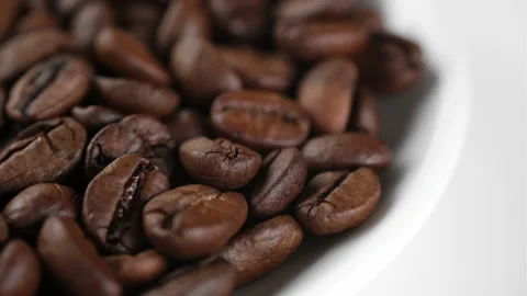 Roasted coffee beans in white plate, rotate Video stock 248126714