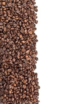 Roasted coffee beans on a white surface Stock Photos