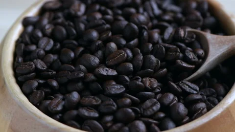 Roasted coffee beans with wood spoon spinning, Stock Footage 172539232