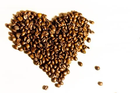 Roasted coffee grains lying in the shape of the heart Stock Photos