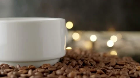 Roasted coffee grains top view. a cup of hot coffee. white cup on black coffee Stock Footage 164594528