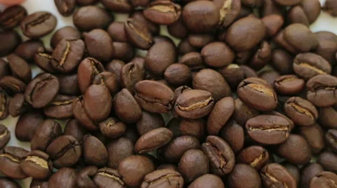 Roasted coffee spilling on white table Stock Footage 68999820