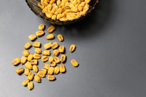 Roasted corn nuts in plate on dark background Stock Photos