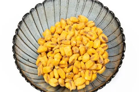 Roasted corn nuts in plate on white background Stock Photos