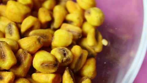 Roasted corn seeds on pink background Stock Footage 151865083