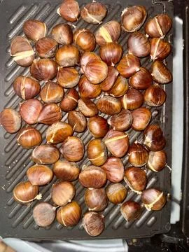 Roasted cracked chestnuts Stock Photos