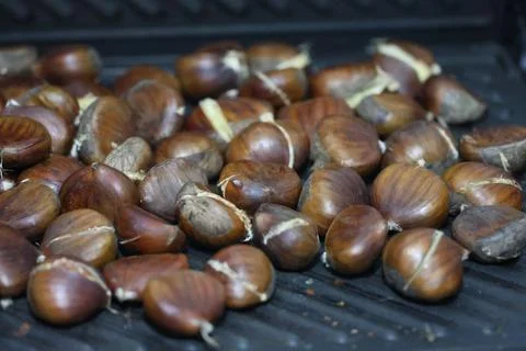 Roasted cracked chestnuts Stock Photos