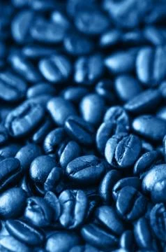 Roasted dark coffee beans background. Close up. Stock Photos