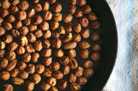 Roasted dried hazelnuts on iron pan Stock Photos