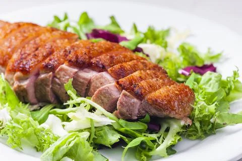 Roasted duck breast with green salad Stock Photos
