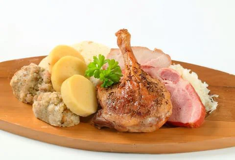 Roasted duck leg with mashed potatoes and sides Stock Photos