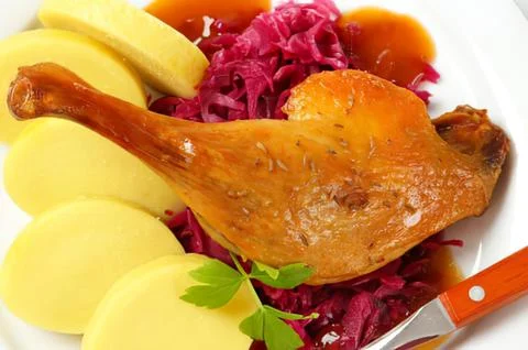 Roasted duck leg with red cabbage and potatoes Stock Photos
