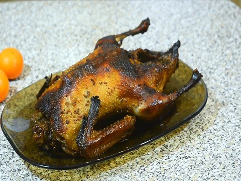 Roasted duck on a platter next to mandarins Stock Footage 72717430