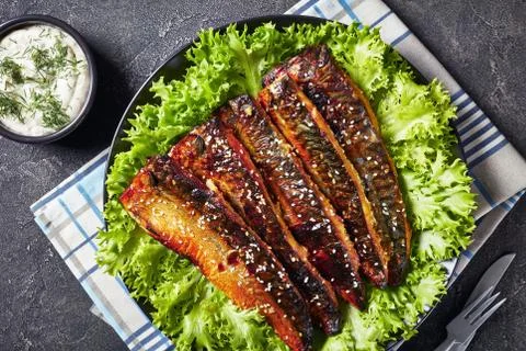 Roasted fillets of mackerel fish with lettuce Stock Photos