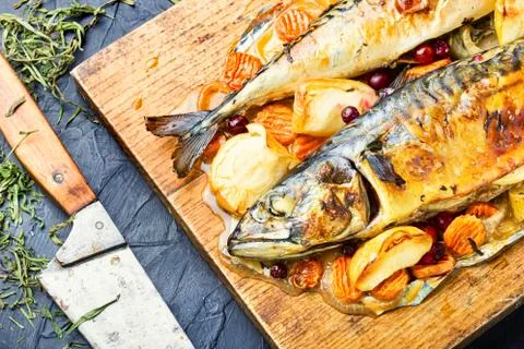 Roasted fish with apple. Stock Photos