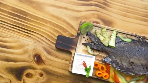 Roasted fish with vegetable garnish in bbq restaurant. Food composition grilled Stock Footage 104556295