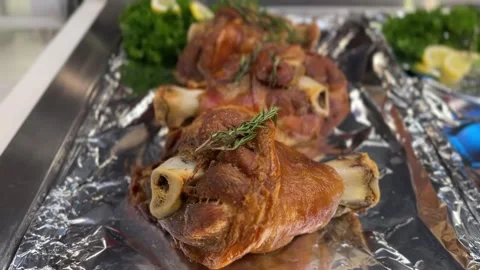 Roasted German pork knuckles with crispy skin, bone, and rosemary Stock Footage 316812781