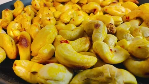 Roasted golden cashew nuts in black plate, top view Stock Footage 336471108