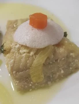 Roasted hake with quail egg hat and carrot Stock Photos