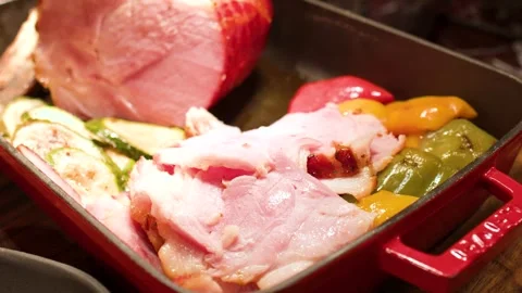 Roasted Ham and Grilled Vegetables in a Red Cast Iron Pan Stock Footage 334919254