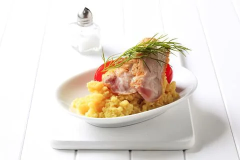 Roasted ham slice with mashed potatoes and garnish Stock Photos