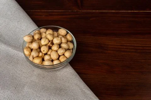 Roasted hazel nuts in a bowl on rustic background Stock Photos