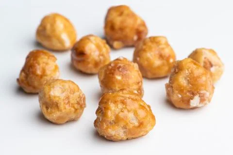Roasted hazelnuts in caramel on a white background Stock Photos