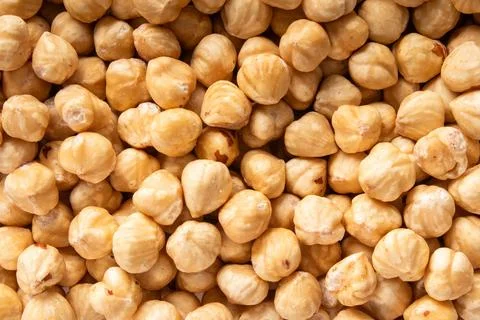 Roasted hazelnuts closeup, shelled nuts background, healthy snack Foto stock