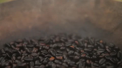 Roasted, hot coffee beans being smoked in a basin in Ethiopia Stock Footage 336367963