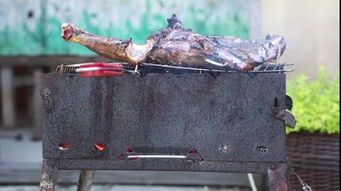 Roasted Lamb Leg Grilling Over Charcoal Barbecue 動画素材 345355655