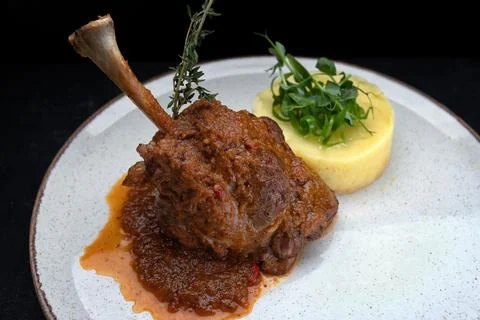 Roasted lamb leg with mashed potatoes Stock Photos